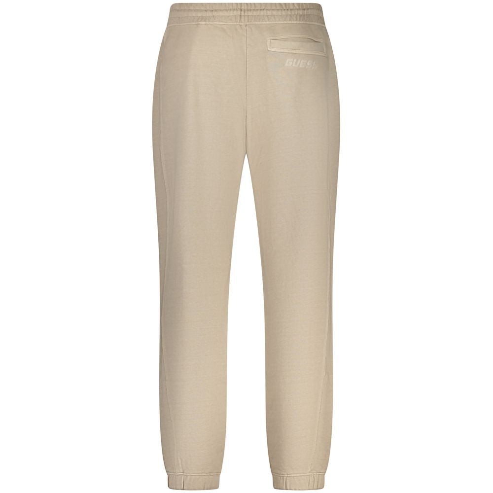 Rear view of Guess Jeans Beige Cotton Pant with elastic waist, ankle cuffs, and 3 pockets. Features print and embroidered logo detail.