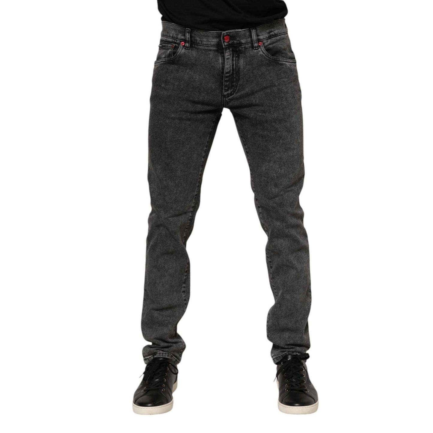 Man wearing Dolce & Gabbana black washed denim jeans with zipper closure and logo plaque detail, skinny fit.