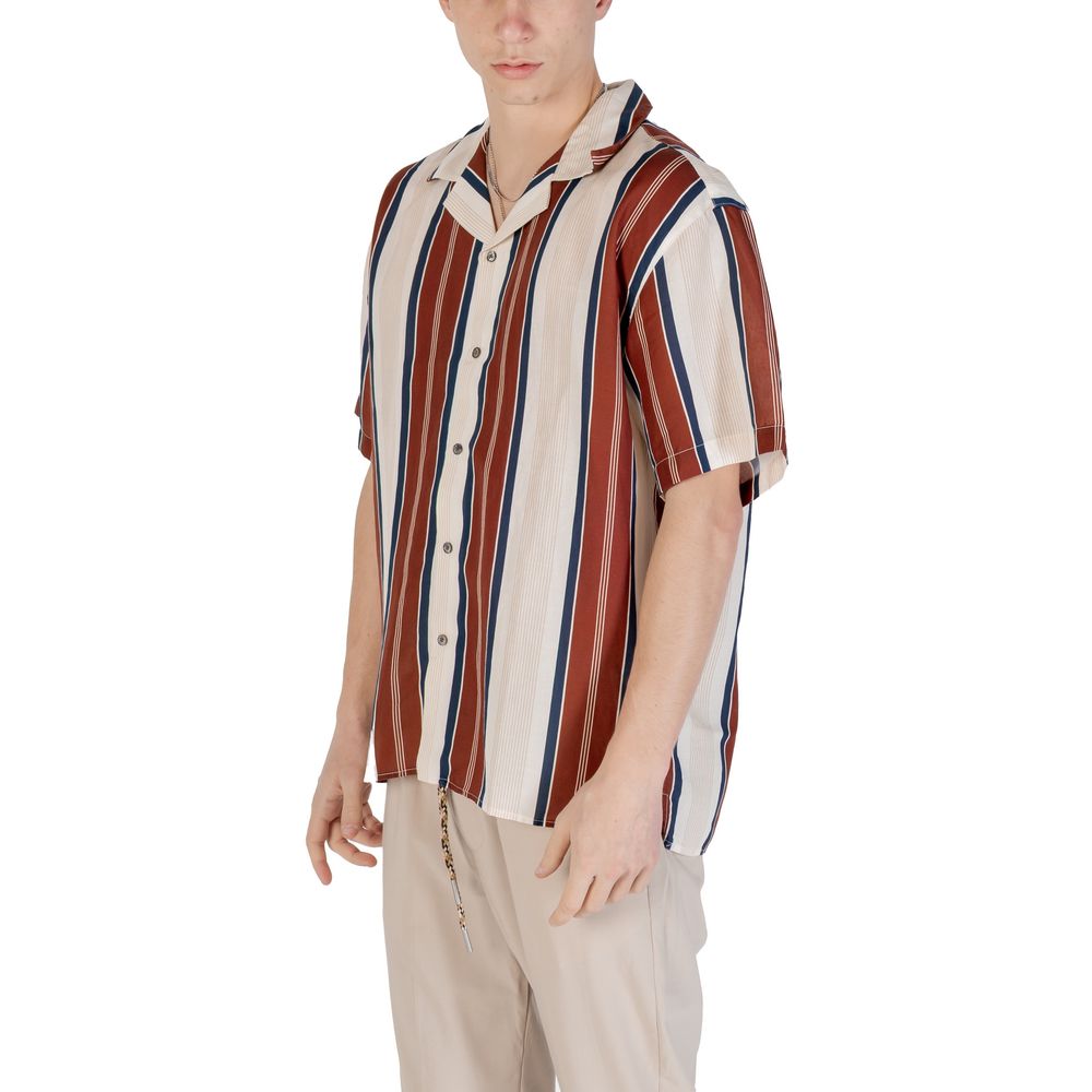 Man wearing a stylish striped short-sleeve shirt with beige trousers, perfect for casual and summer looks.