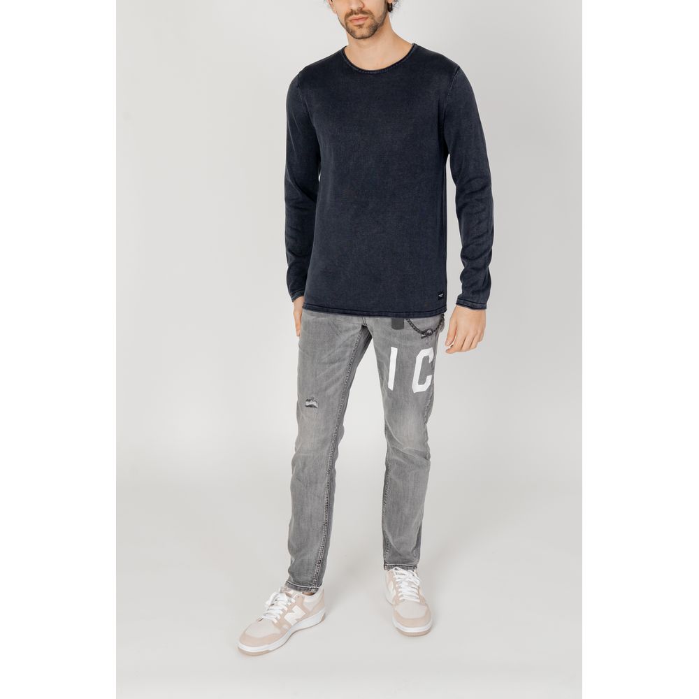 Model wearing Jack Jones Blue Cotton Sweatshirt with gray jeans and white sneakers, showcasing casual style.