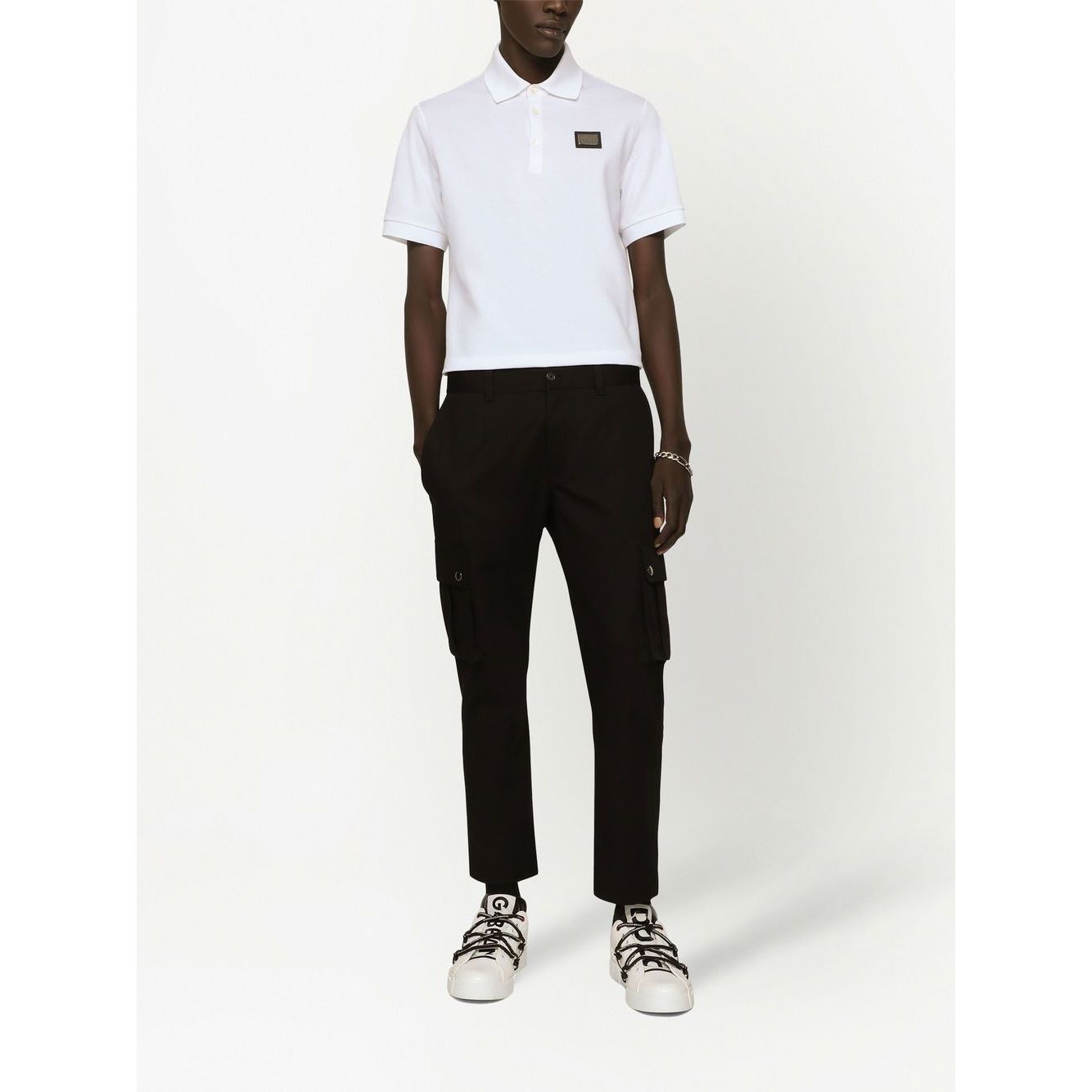 Dolce & Gabbana Logo cotton polo shirt in white, featuring a piqué weave, short sleeves, and a classic straight hem, worn by a model.