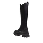 Side view of GANNI Boots Black with faux-leather upper, chunky lug sole, elasticated side panels, and double pull-tab opening.