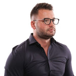 Man wearing Lozza Black Men Glasses Frame in a black shirt demonstrating full-rim round style optical eyeglasses.