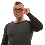 Man wearing Ermenegildo Zegna Black Men Glasses Frame, holding the glasses while smiling.