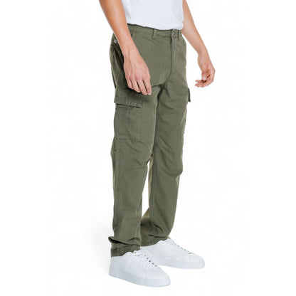 Model wearing Jack Jones Green Cotton Cargo Pants with side flap pockets and tapered fit, perfect for all-day comfort and style.