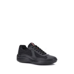 Prada America's Sneakers in black with leather and fabric panels, featuring lace-up closure and textured sole for comfort and style.