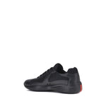 Prada America's Sneakers in black with lace-up closure, leather and fabric panels, and textured sole for comfort and style.