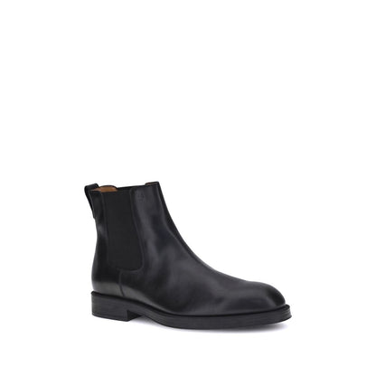 Tod's Black Calf Leather Bos Taurus Chelsea Boots with elastic side inserts and back tab for easy fit.