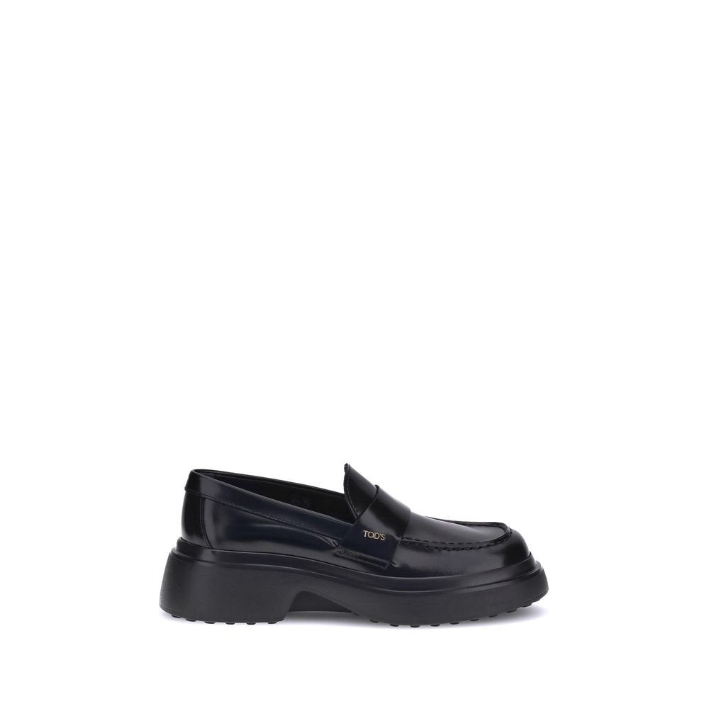 Alt Tag: Tod's Black Rubber Platform Loafers with patent leather upper and distinctive logo plaque, featuring a contemporary rubber sole design.