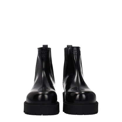 Givenchy Black Leather Ankle Boots with logos, round toe, rubber sole, and mid heels.