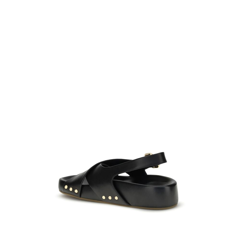 Chloé Mae Sandals with black calfskin, gold studs, and Paddington buckle, showing back and side view of sandal with crossed straps.