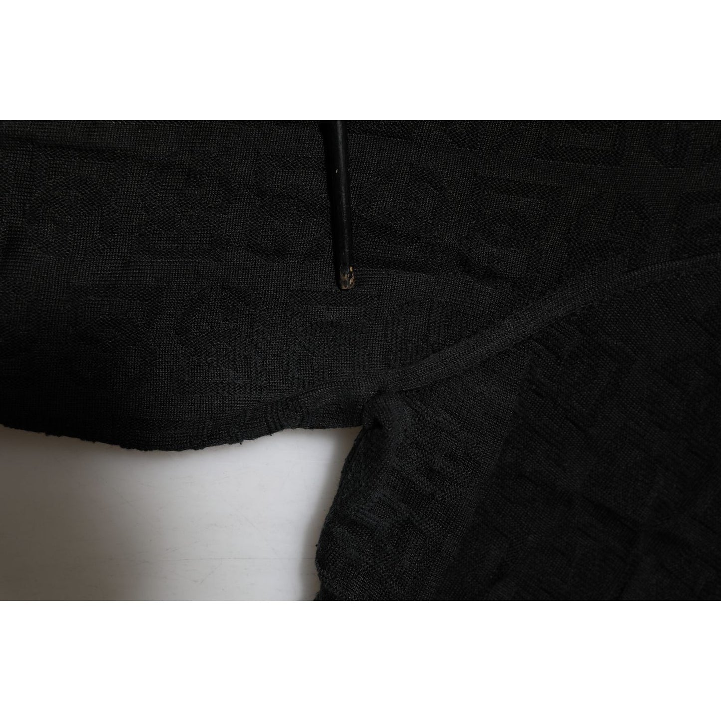 Close-up of Dolce & Gabbana Black Silk Jacquard DG Polo Shirt T-shirt with monogram pattern, showcasing the detailed texture.