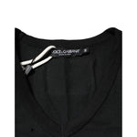 Close-up of Dolce & Gabbana Black Cotton Tattered Logo V-Neck Men T-shirt, featuring punched-hole design and black fabric label.