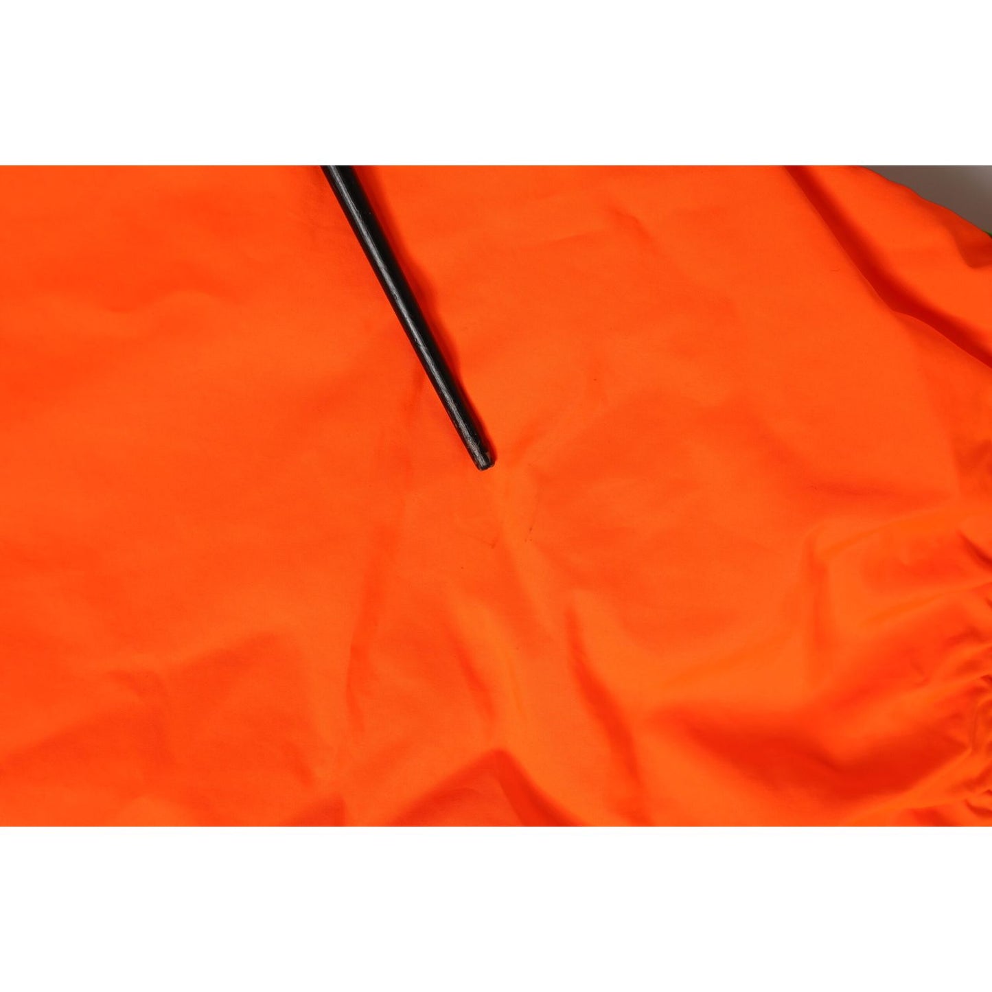 Close-up of Dolce & Gabbana Orange Polyester Beachwear Men Shorts Swimwear fabric.