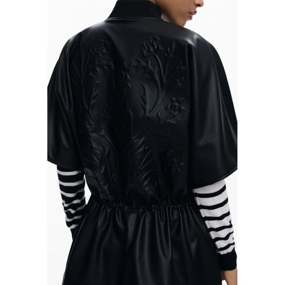 Back view of Desigual Black Polyethylene Women Poncho with embossed floral print and drawstring waist for a chic silhouette.