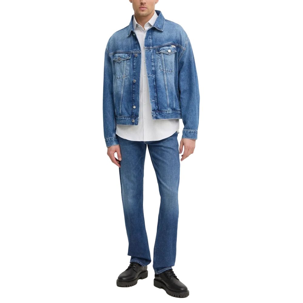 Calvin Klein Jeans Blue Cotton Relaxed Fit Jeans model, full view with denim jacket and black shoes.