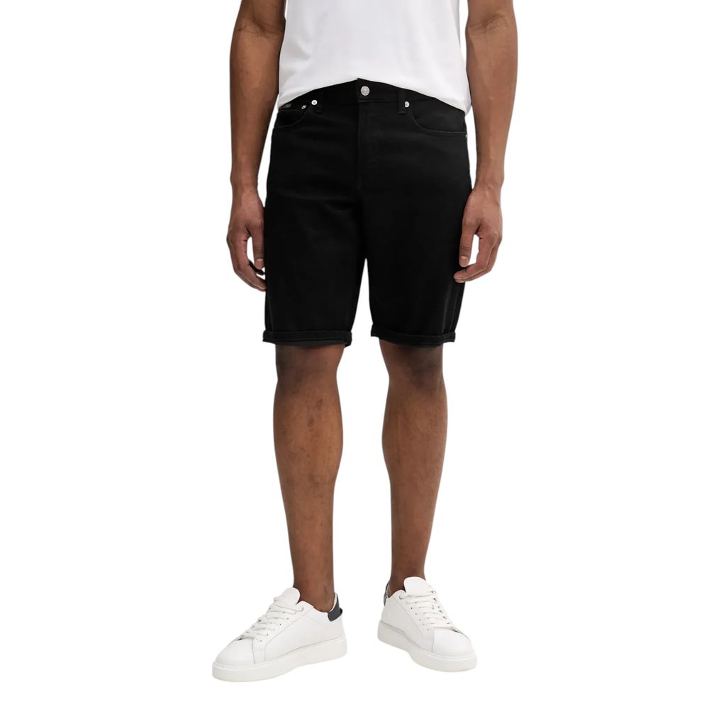 Model wearing Calvin Klein Jeans Black Cotton Bermuda Shorts, showcasing a versatile summer casual outfit.