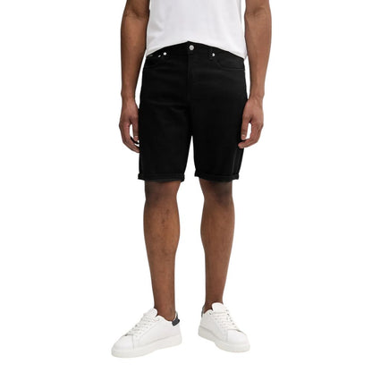 Model wearing Calvin Klein Jeans Black Cotton Bermuda Shorts, showcasing a versatile summer casual outfit.