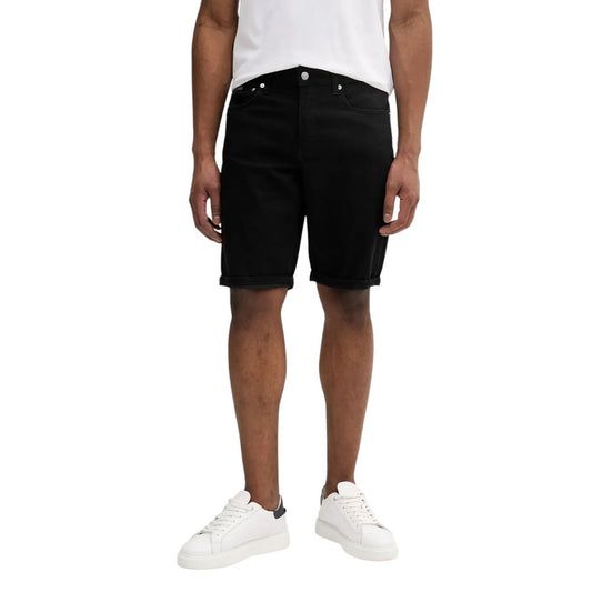 Model wearing Calvin Klein Jeans Black Cotton Bermuda Shorts, showcasing a versatile summer casual outfit.