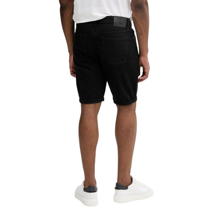 Back view of man wearing Calvin Klein Jeans Black Cotton Bermuda Shorts with white sneakers.