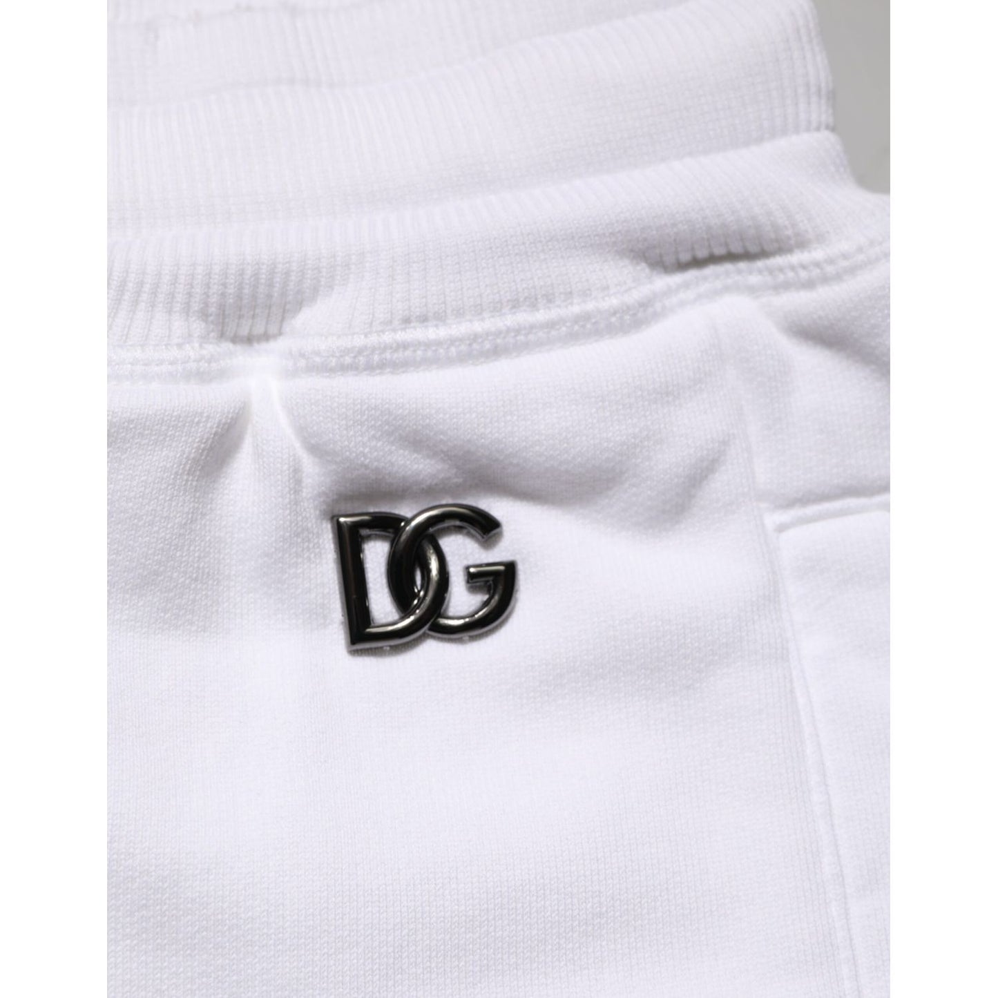 Dolce & Gabbana White Cotton Ripped Bermuda Sweatpants Shorts with DG logo detail on the waistband, showcasing luxury craftsmanship.
