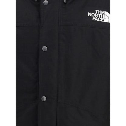 Close-up of The North Face Black Polyester Coat with logo and buttons.