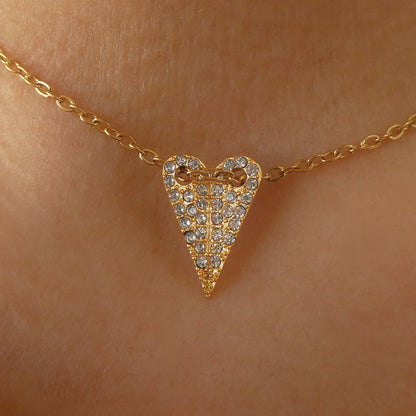 Gold heart pendant necklace by AN JEWELS JEWELRY Mod. AL.NMOH24CZ on skin, sparkling with embedded stones