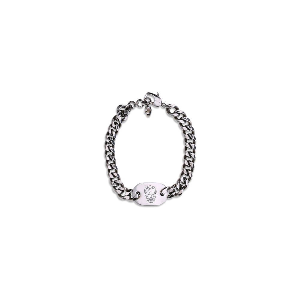 Alt Tag: Alexander McQueen Silver Brass Bracelet with skull charm and antiqued finish on white background.