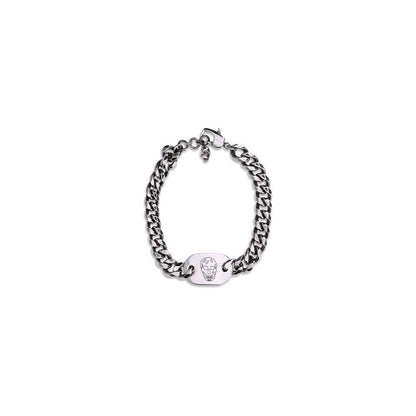 Alt Tag: Alexander McQueen Silver Brass Bracelet with skull charm and antiqued finish on white background.