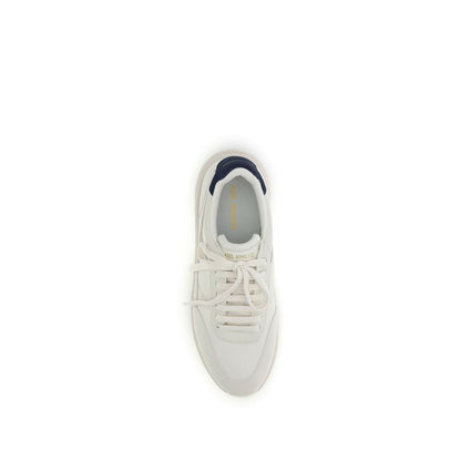 Top view of Axel Arigato White Leather Athletic Sneakers with gold logo and navy detail.