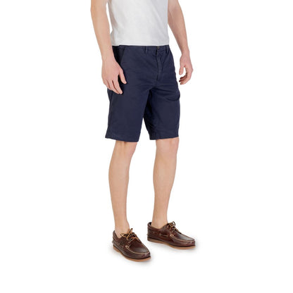 Man wearing Borghese Blue Cotton Bermuda Shorts with casual attire, showcasing style and comfort for summer.