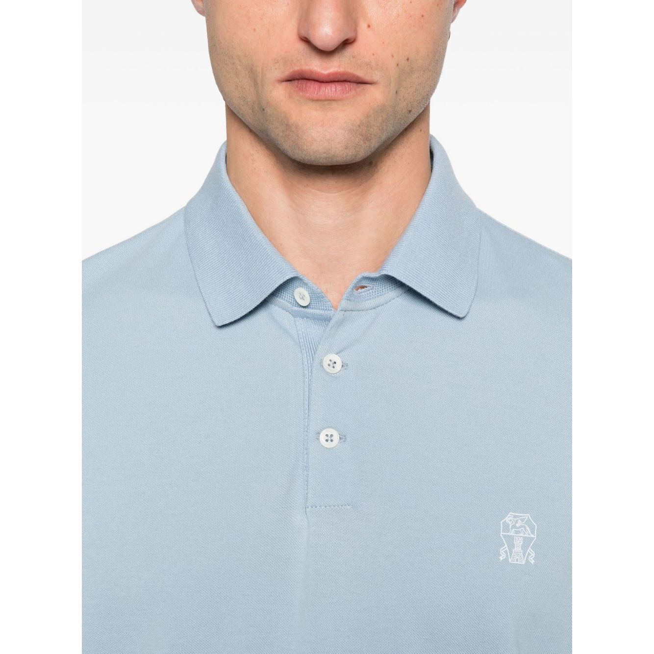 Brunello Cucinelli Polo shirt with embroidery in light blue cotton, featuring short sleeves, button placket, and embroidered logo detail.