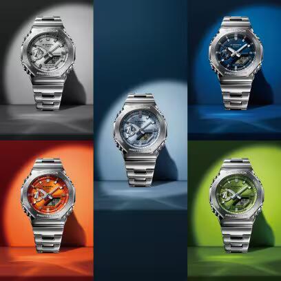 Various models of CASIO G-SHOCK Mod. OAK G-STEEL PETROL BLUE wristwatches with stainless steel straps on colorful backgrounds.