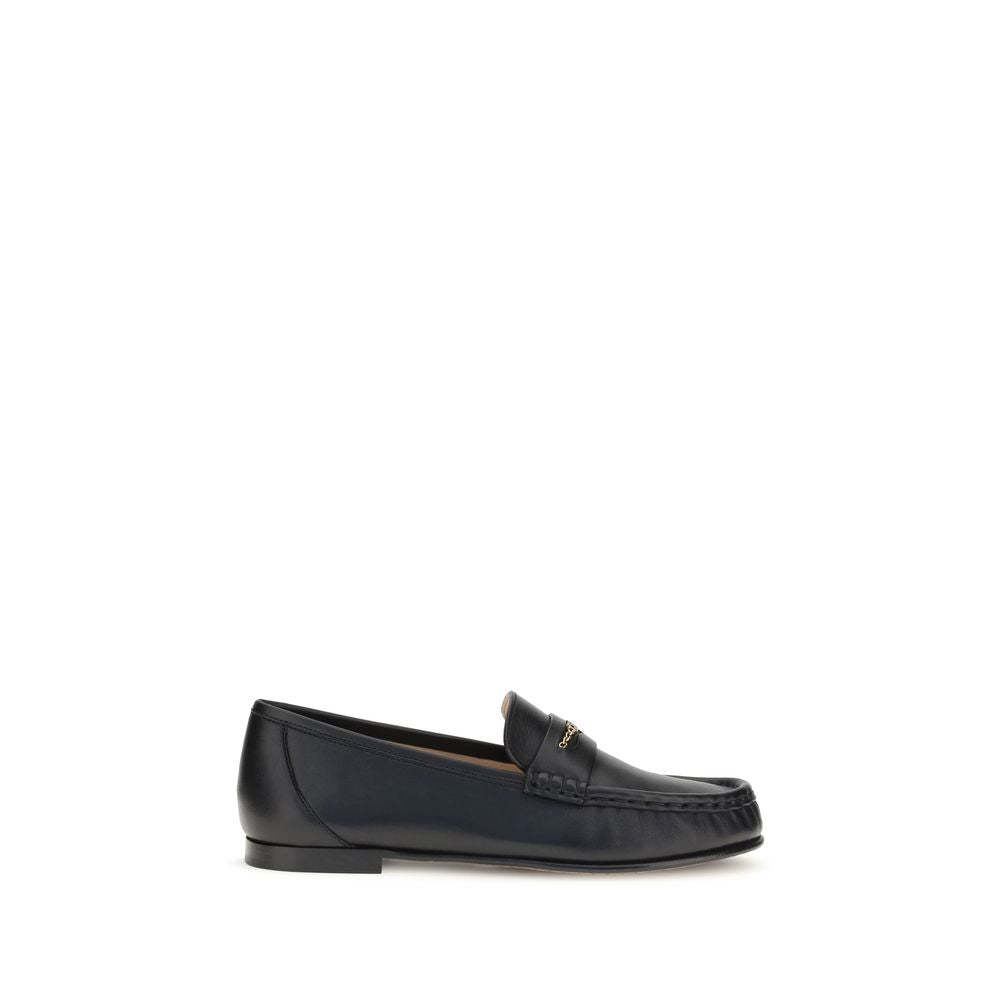 Chloé Black Calf Leather Bos Taurus Slip-On Loafers with gold chain accent on white background