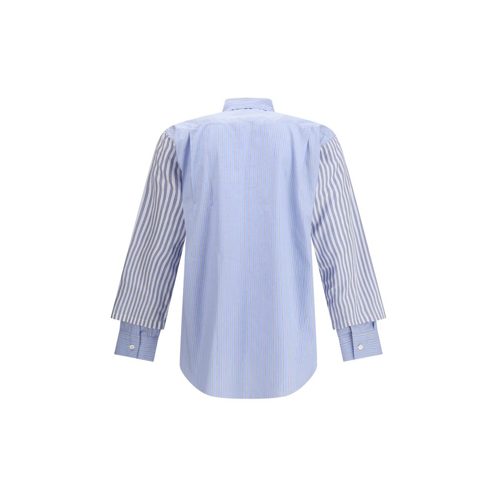 Back view of Comme Des Garçons Light Blue Cotton Pattern Shirt with subtle stripes and double cuffs, showcasing avant-garde fashion design.