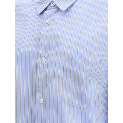 Comme Des Garçons Light Blue Cotton Pattern Shirt with subtle stripes and double cuffs, featuring a refined and contemporary design.