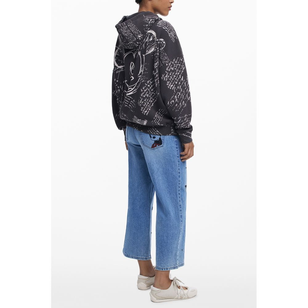 Woman wearing Desigual Black Cotton Women Hoodie with Mickey print, styled with blue jeans and sneakers.