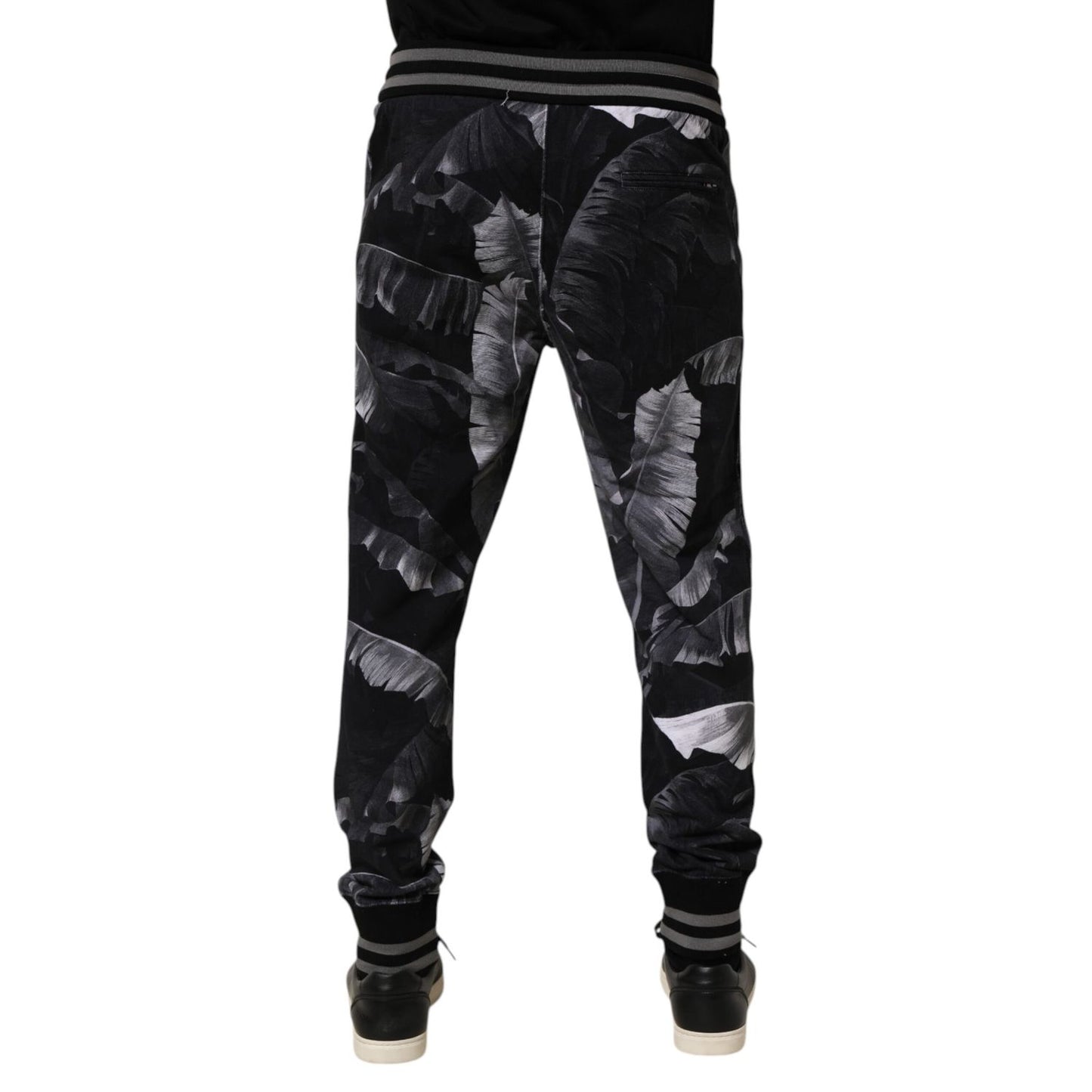 Rear view of Dolce & Gabbana Black Banana Leaf Cotton Jogger Trouser Pants with elastic waistband and ribbed cuffs.