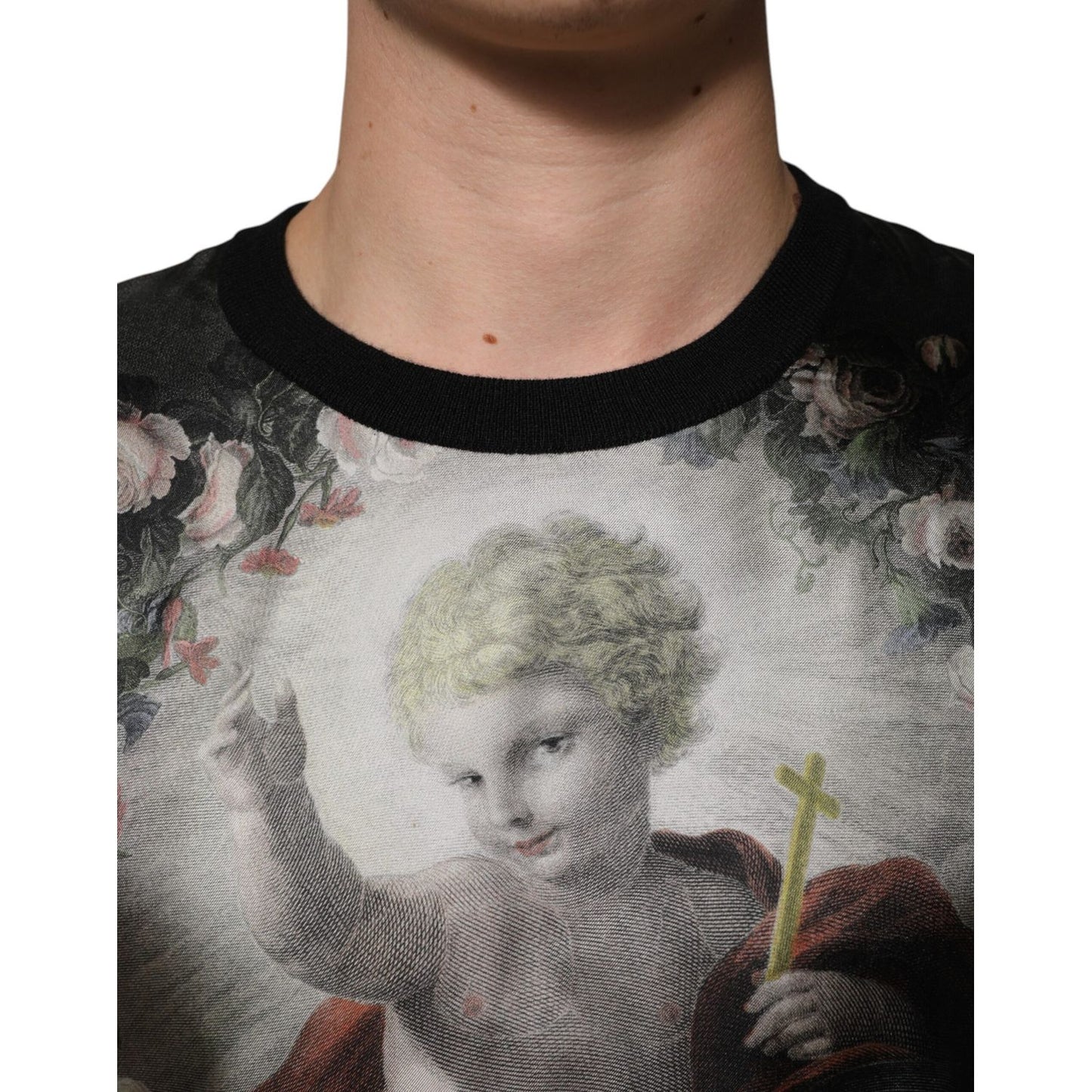 Dolce & Gabbana Black Cashmere Cherub Print Baroque Sweater with Baroque-inspired design on a model's chest, close-up view.