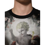 Dolce & Gabbana Black Cashmere Cherub Print Baroque Sweater with Baroque-inspired design on a model's chest, close-up view.