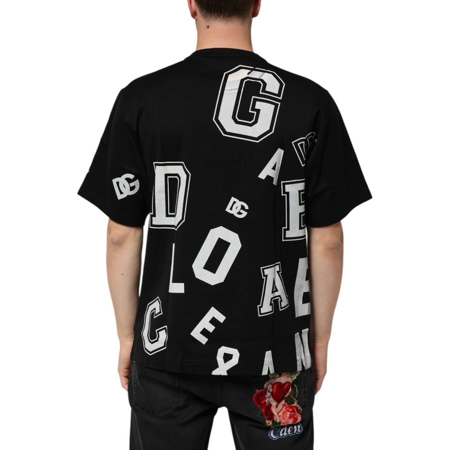 Man wearing Dolce & Gabbana Black Cotton Letter Print Short Sleeve T-shirt with white varsity-style lettering on back