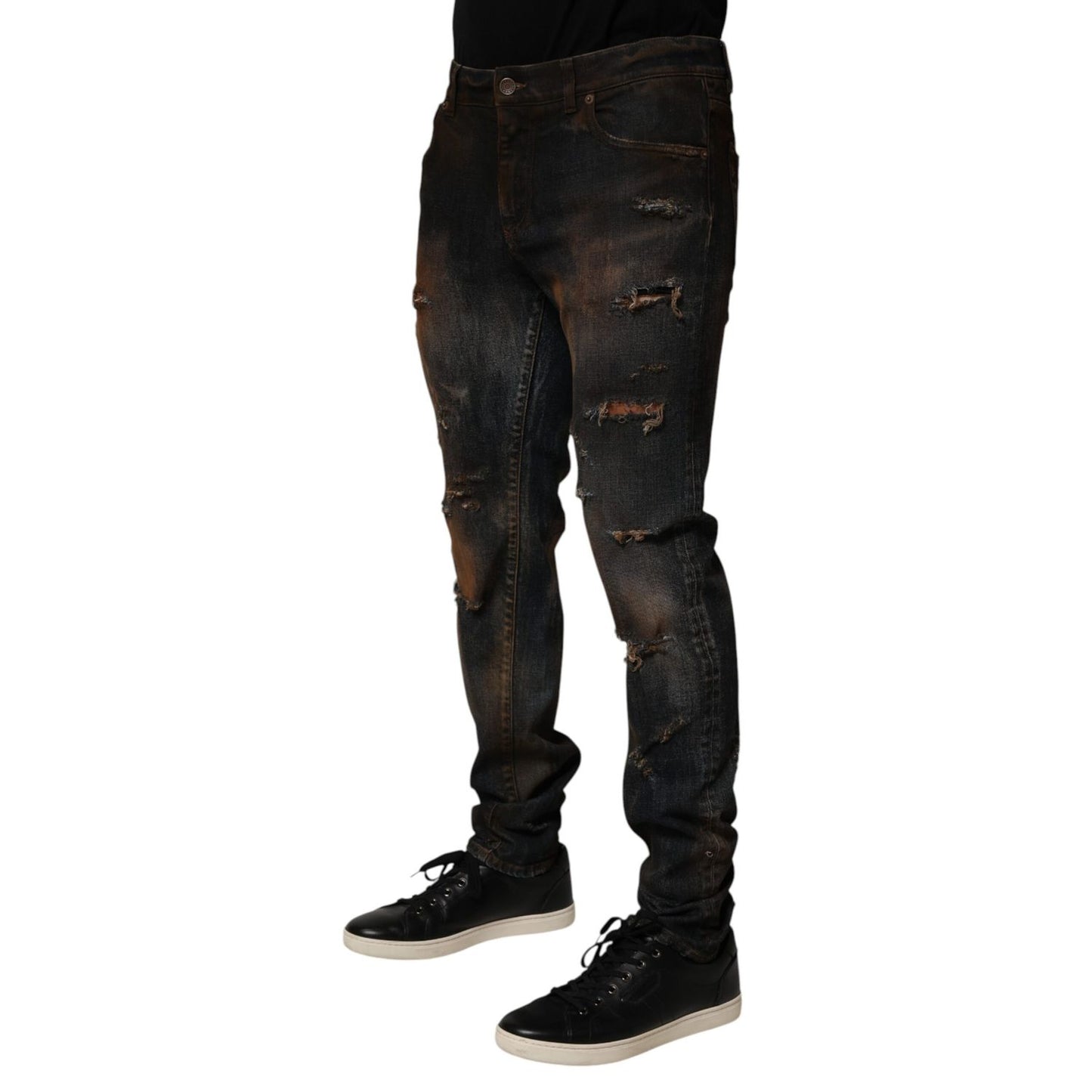 Model wearing Dolce & Gabbana Black Cotton Skinny Tattered Men Denim Jeans with sneakers, showcasing the sleek and edgy design.