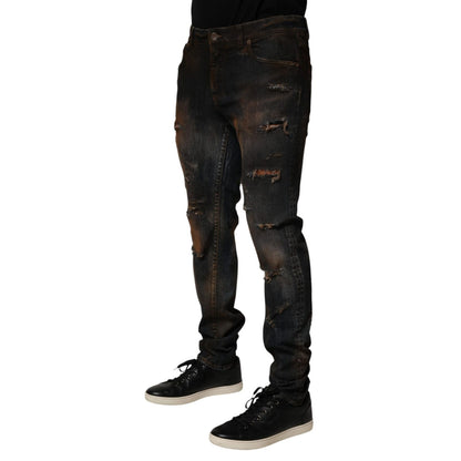 Model wearing Dolce & Gabbana Black Cotton Skinny Tattered Men Denim Jeans with sneakers, showcasing the sleek and edgy design.