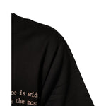 Close-up of Dolce & Gabbana Black Marilyn Monroe Cotton Crew Neck T-shirt showcasing fabric detail and partial text.