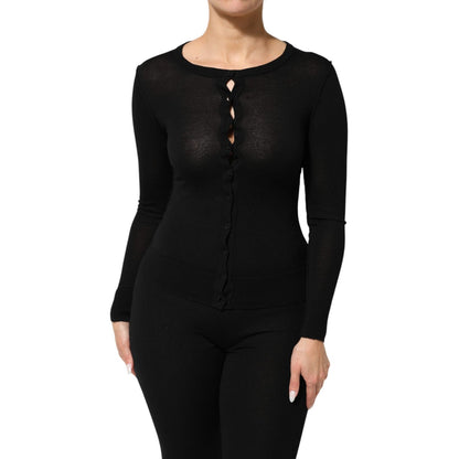 Model wearing Dolce & Gabbana Black Virgin Wool Buttoned Cardigan Sweater showcasing classic design and ribbed cuffs detail.