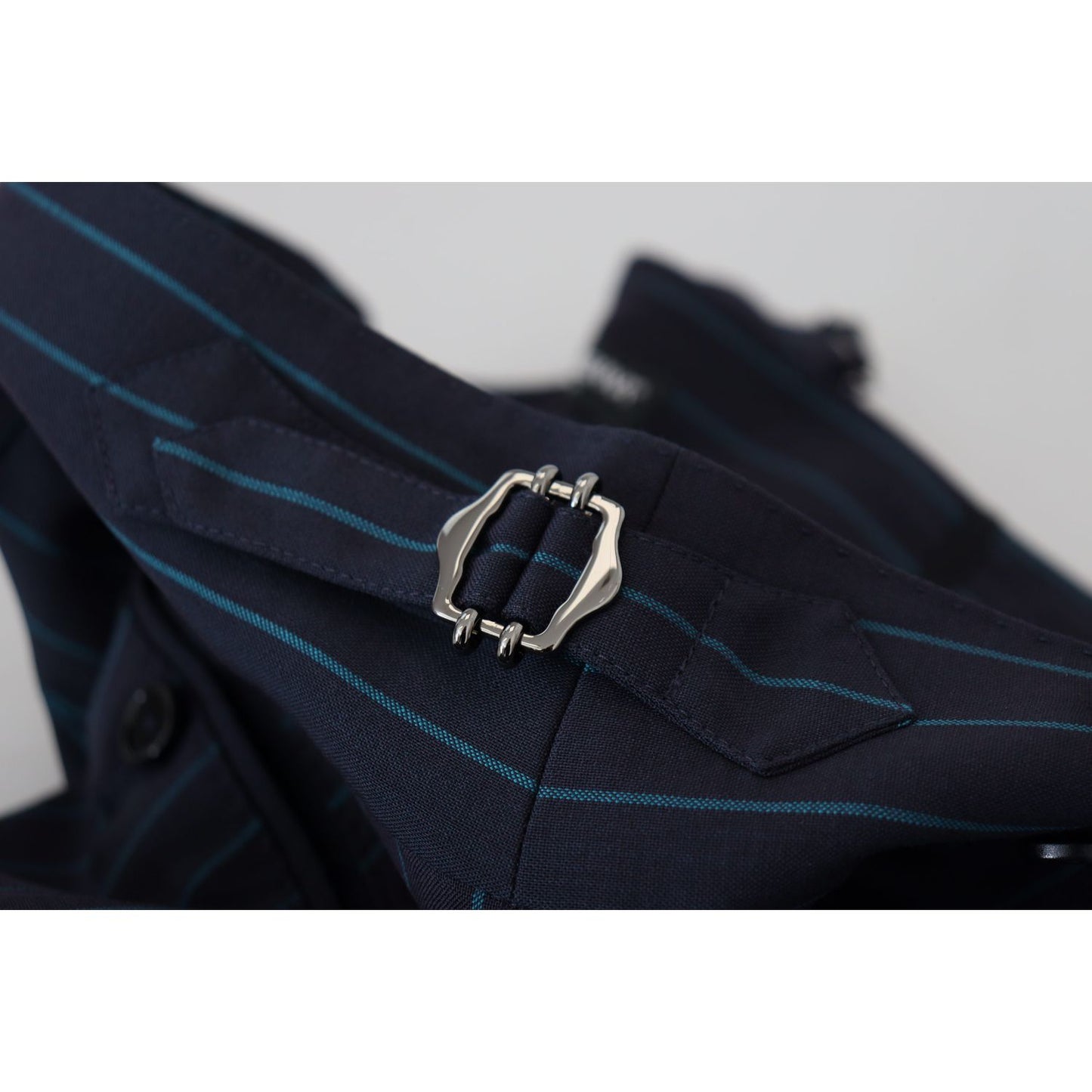 Close-up of Dolce & Gabbana Blue Striped Men Formal Pants showcasing buckle detail, elegant design, 100% virgin wool, made in Italy.