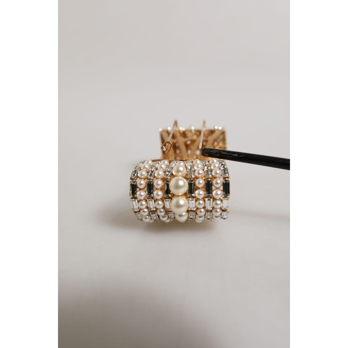 Close-up of Dolce & Gabbana Gold Brass Glas Crystal Faux Pearl Embellished Brooch with intricate details and luxury design.