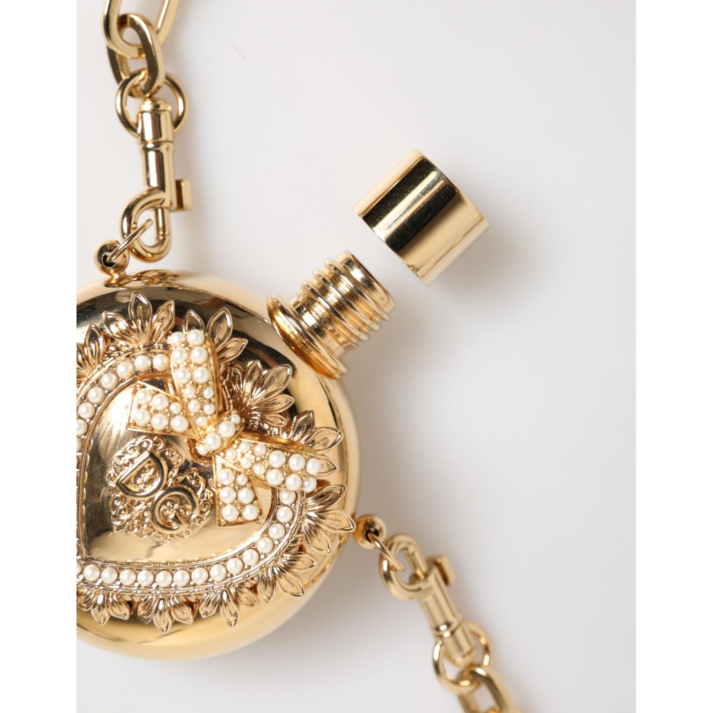 Close-up of Dolce & Gabbana Gold Brass Rhinestone Devotion Charm Pendant Necklace with open pendant and logo detail.
