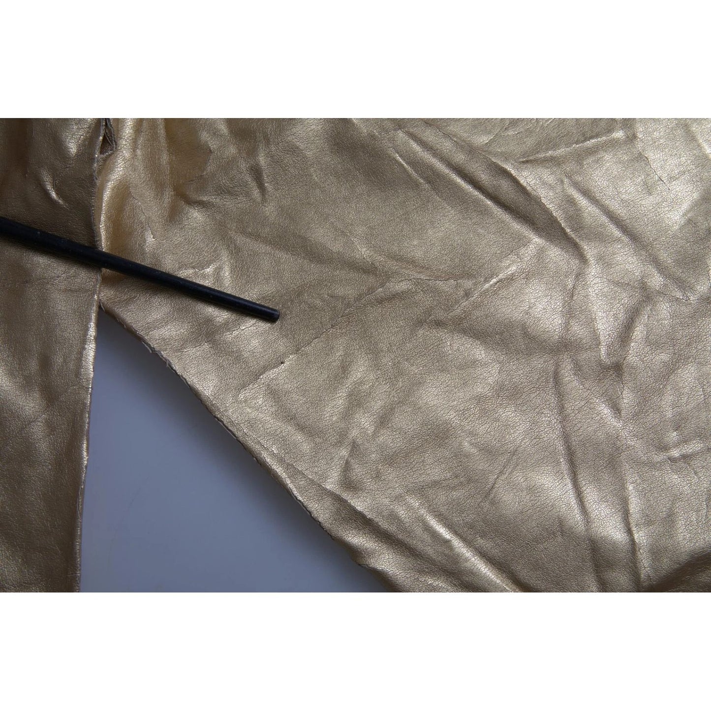 Fabric detail of Dolce & Gabbana Gold High Waist Skinny Women Metallic Pants showing texture and minor color defects.