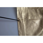 Close-up of Dolce & Gabbana Gold High Waist Skinny Women Metallic Pants showing minor defect with missing color detail.